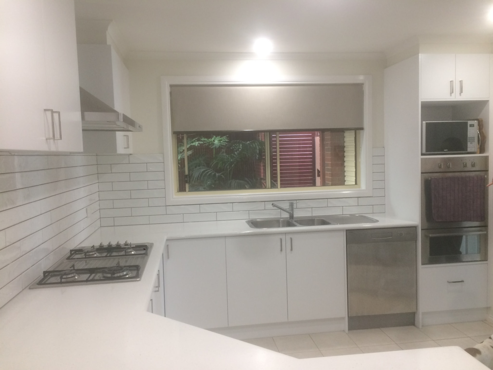 Resurfaced kitchen sink run and appliance tower in white