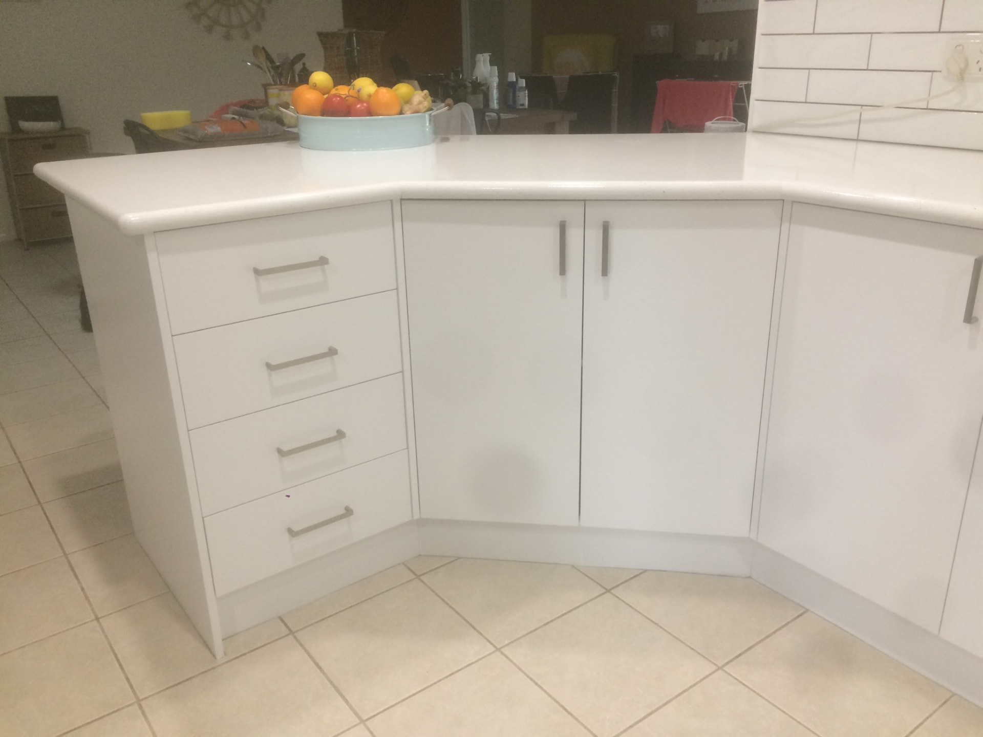 Close-up of resurfaced white drawer fronts and benchtop edge